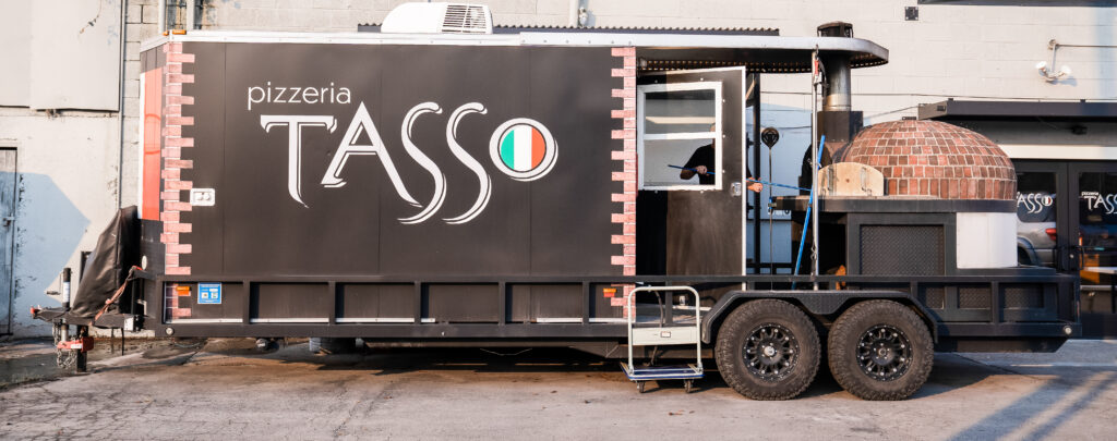 Pizzeria Tasso's moblie food truck. It is complete with a wood-fired brick oven.